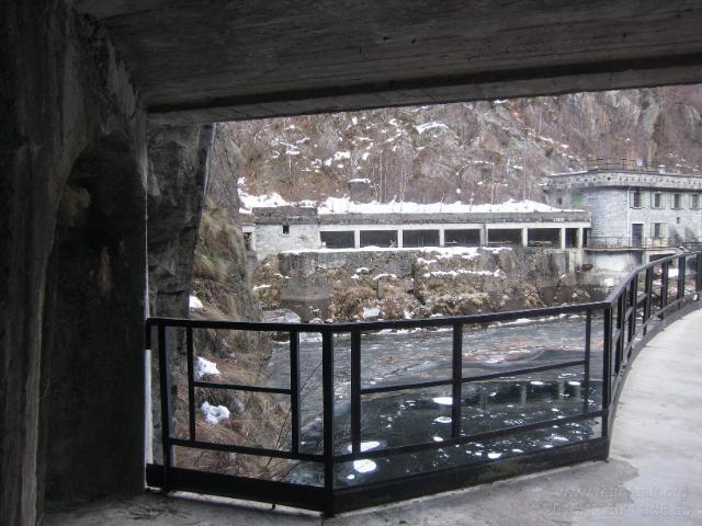 Der nur kurze Tunnel spaltet sich auf, der rechte Tunnel endet direkt an der Mauerkrone, während der linke zum im Hintergund sichtbaren Bahnhof mitsamt Betriebsgebäude führt. (57.17 KByte) Vom